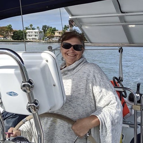Kim Morse at the helm of her sailboat